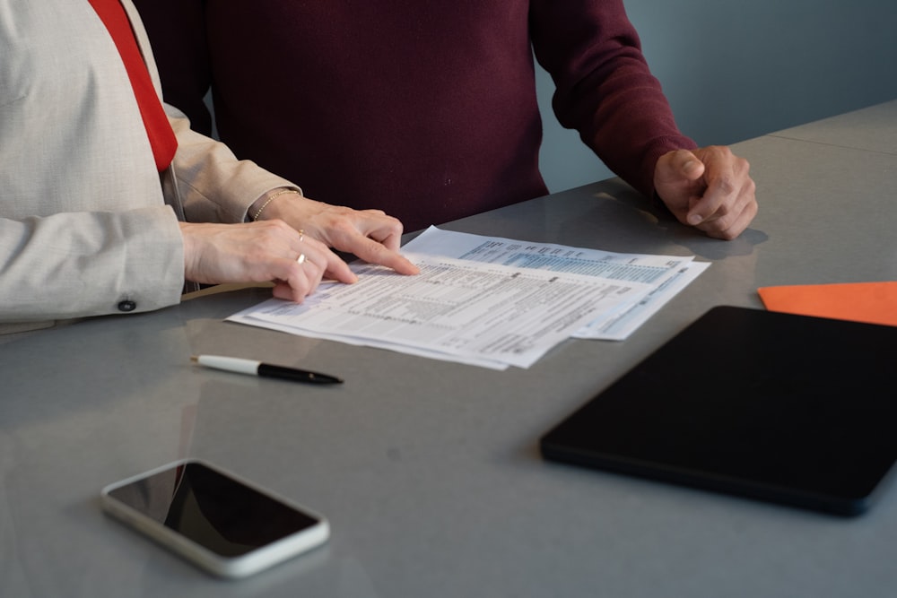 Contract managers reviewing project documents at a table